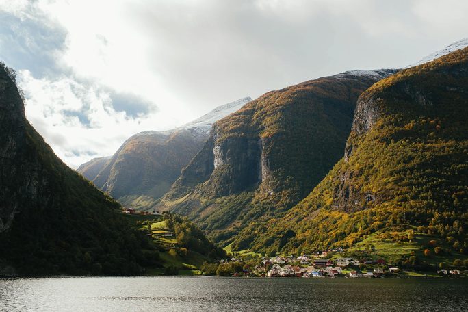 A green fjord valley enclosed by high cliffs